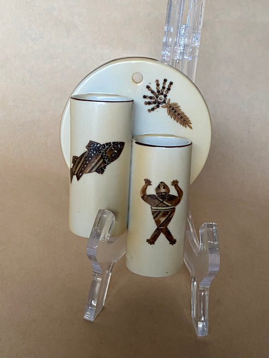 Decorative wall sconce with animal illustrations on a beige background