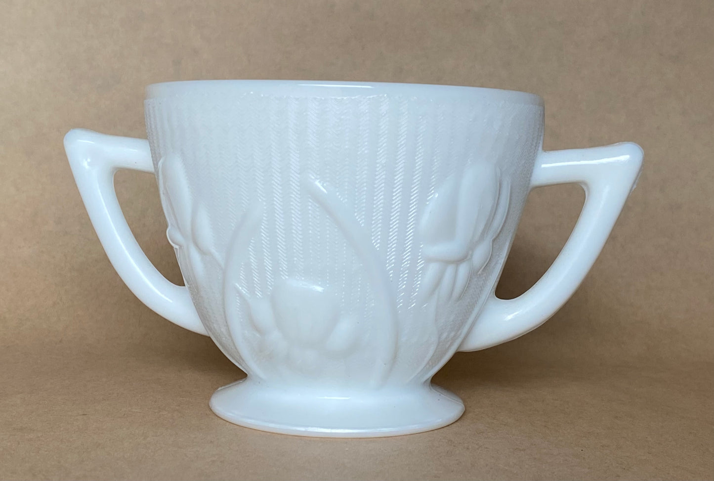 Westmoreland Milk glass creamer with a raised floral or tulip pattern