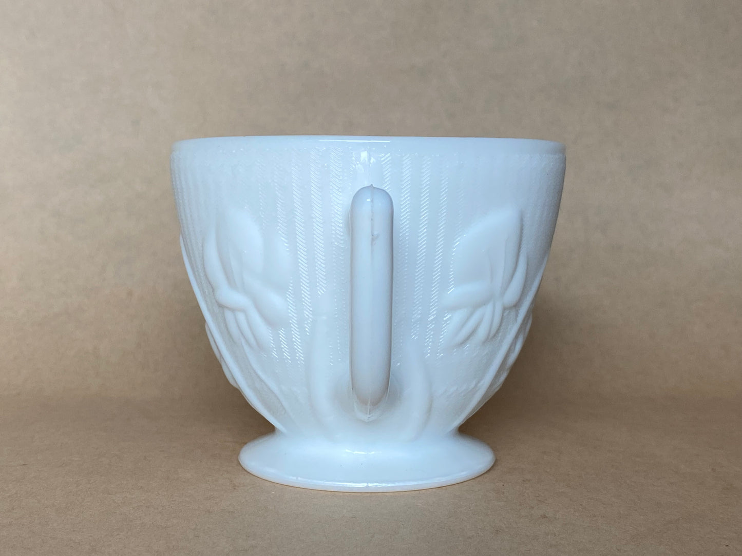 Westmoreland Milk glass creamer with a raised floral or tulip pattern