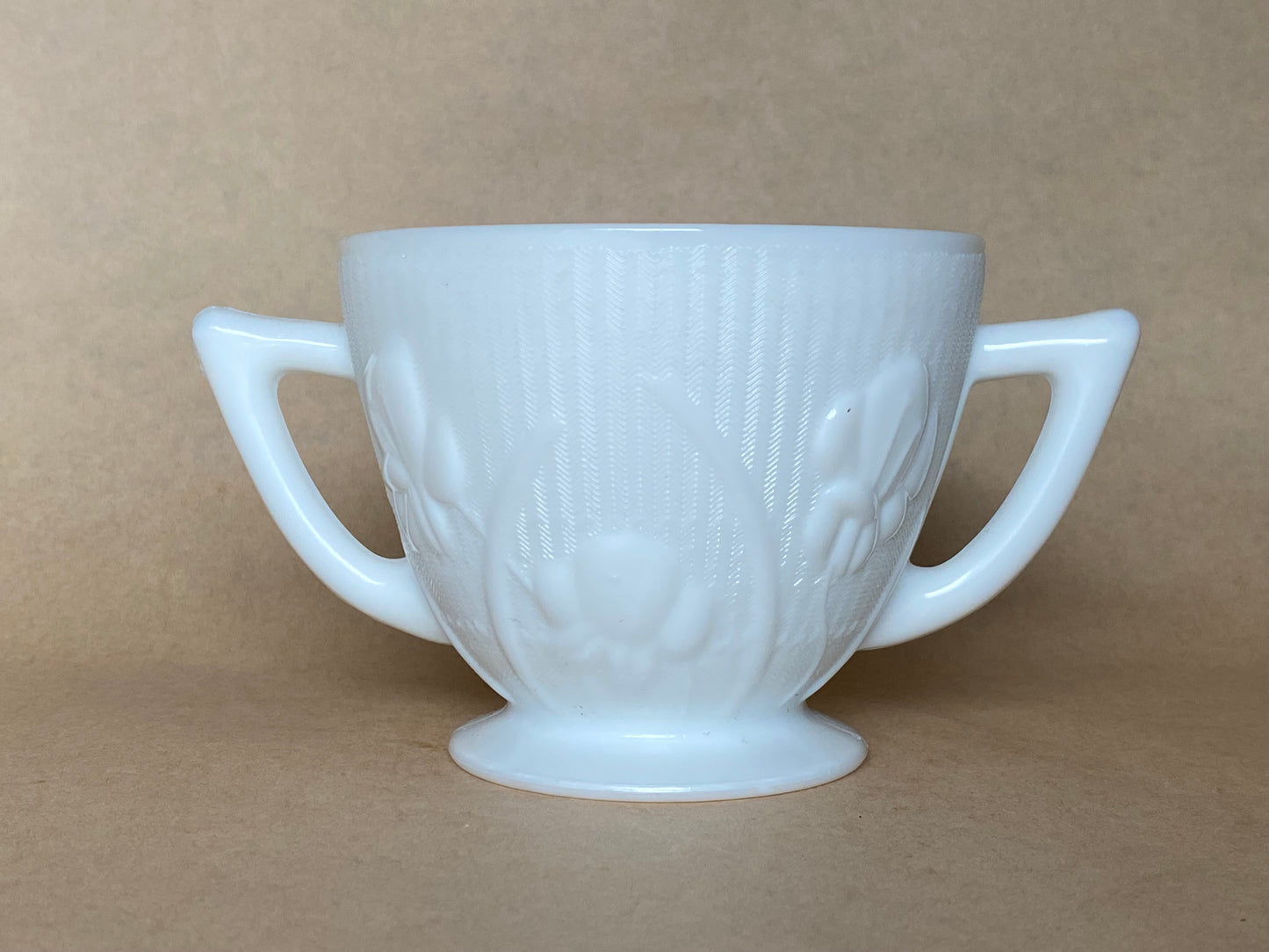 Westmoreland Milk glass creamer with a raised floral or tulip pattern