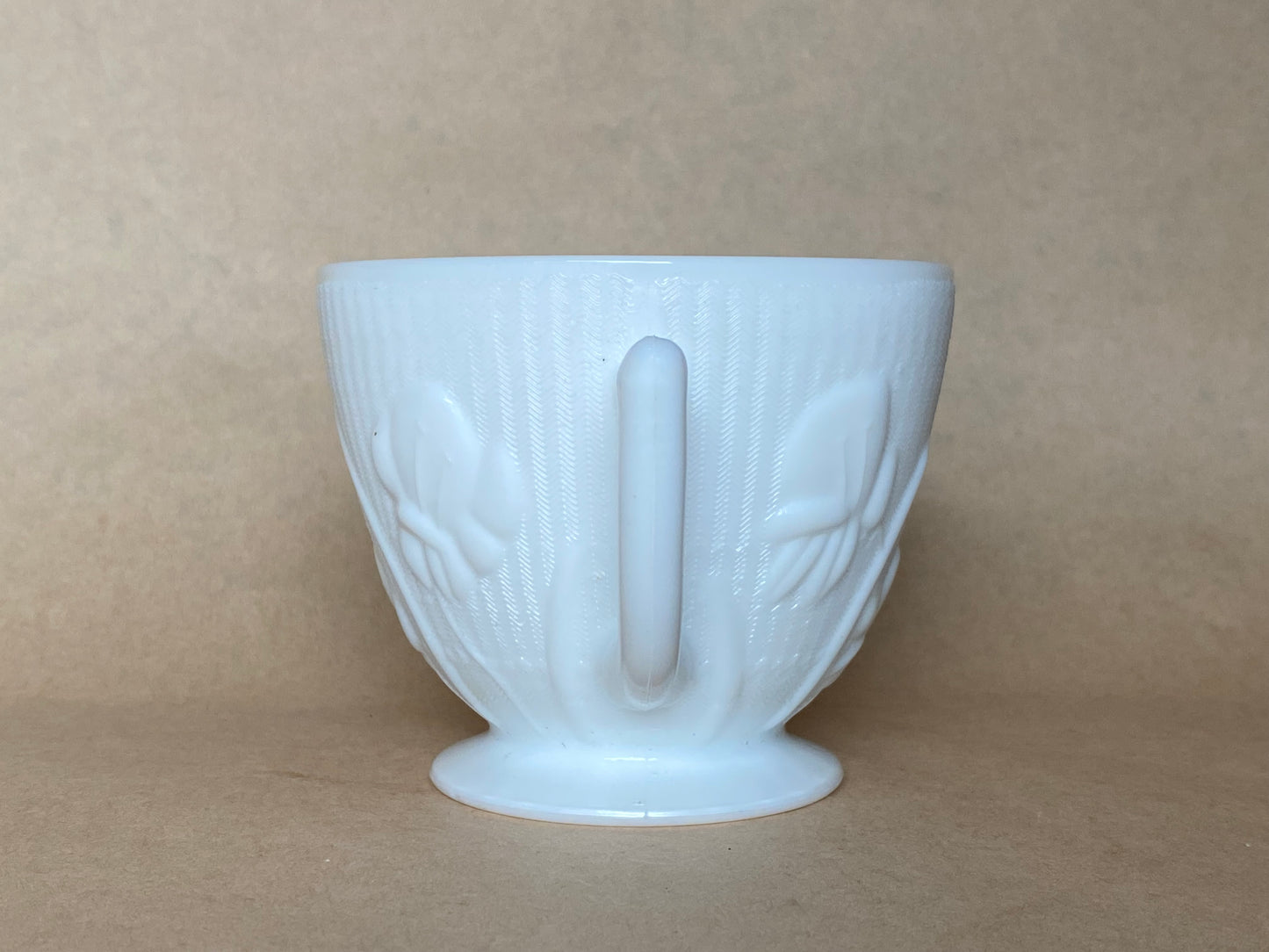 Westmoreland Milk glass creamer with a raised floral or tulip pattern