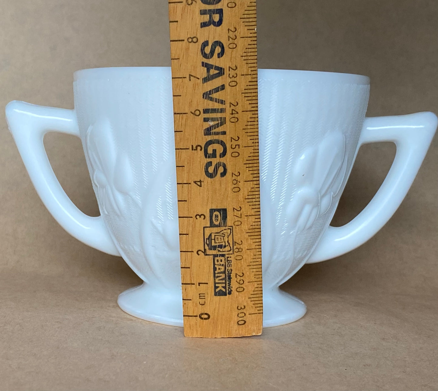 Westmoreland Milk glass creamer with a raised floral or tulip pattern
