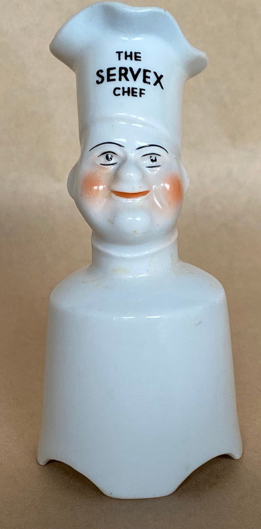 White ceramic chef figurine with 'The Servex Chef' text on a beige background