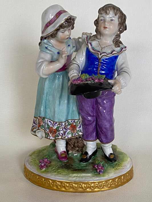 Volkstedt Figurine - Girl and boy harvesting grapes.