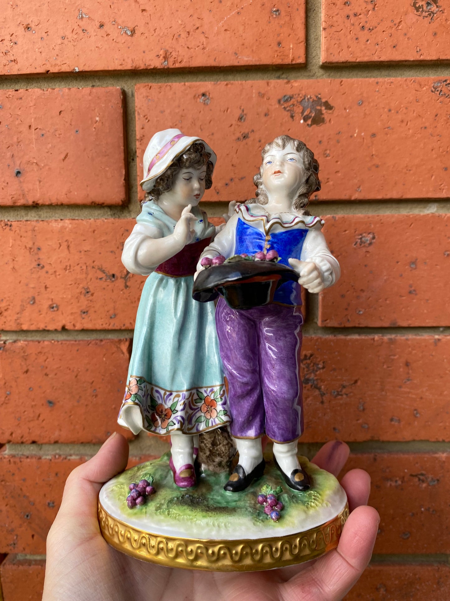 Volkstedt Figurine - Girl and boy harvesting grapes.