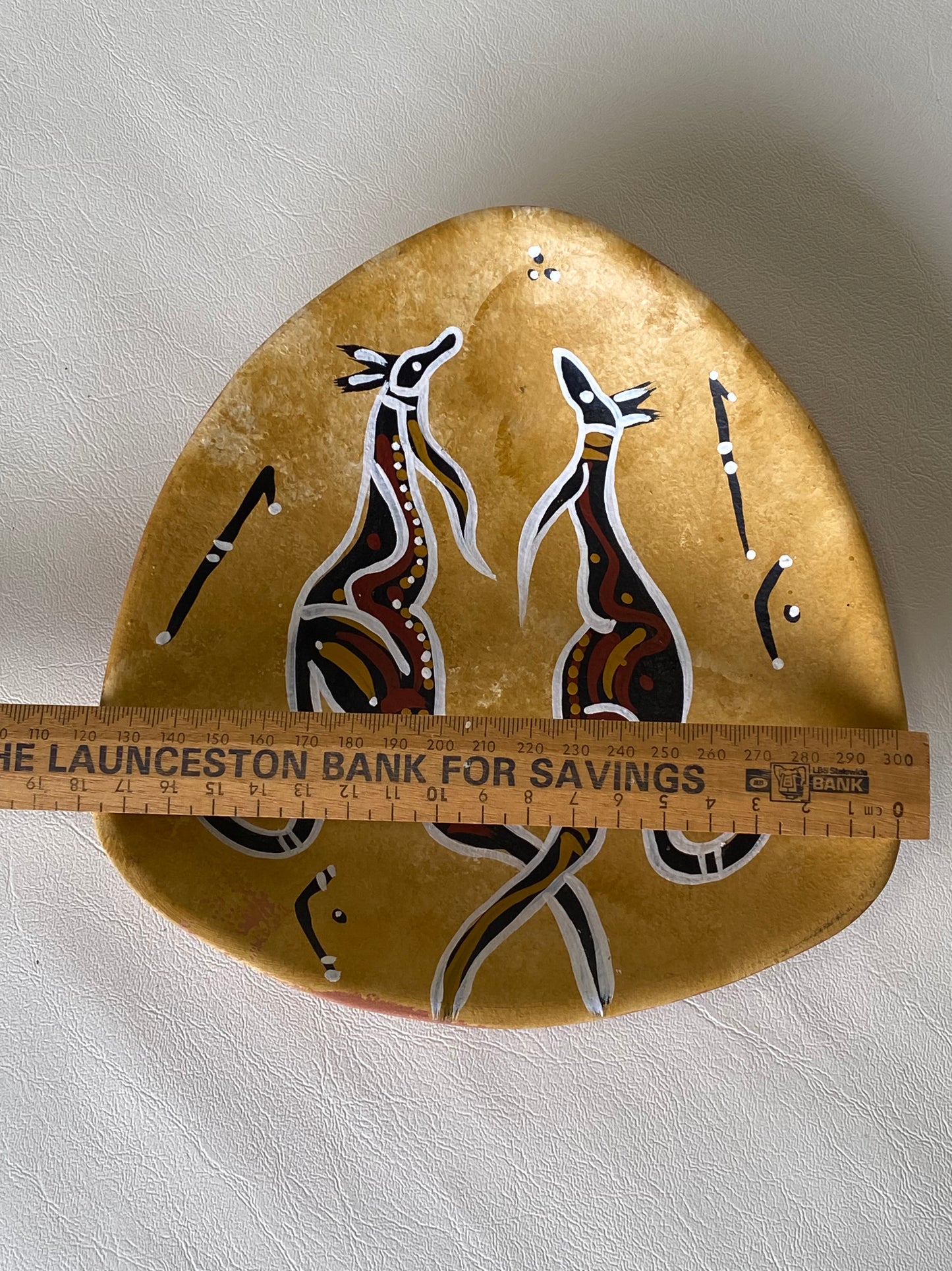 Australiana pottery wall plate with hand painted Aboriginal kangaroo design